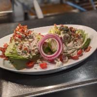 Wedge Salad · A traditional salad with a large iceberg wedge, bacon, tomatoes, and bleu cheese crumbles.