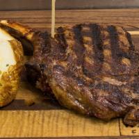 20 oz. Bone-In Rib Eye · Served with a baked potato topped with chives, butter and sour cream.