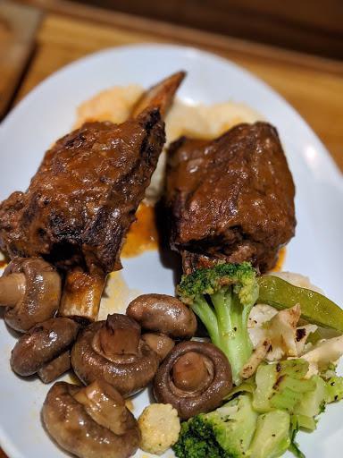 Beef Short Rib · In-house smoked for 8 lon hours to release a deep rich flavor that is tender and bold drizzled with a red wine infused pan sauce and buttery mashed potatoes.