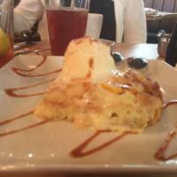 Sissy's Peach Bread Pudding · A grand marnier infused bread pudding, filled with peaches, covered in caramel rum syrup, an...
