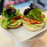 Smoked Salmon Everything Bagel.  · A toasted everything bagel topped with Scallion Cream Cheese, Sliced Cucumber, Tomato, Smoke...