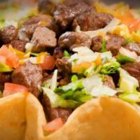 Taco Salad · Large crisp tortilla shell, filled with choice of pinto beans or white rice and a combo of g...
