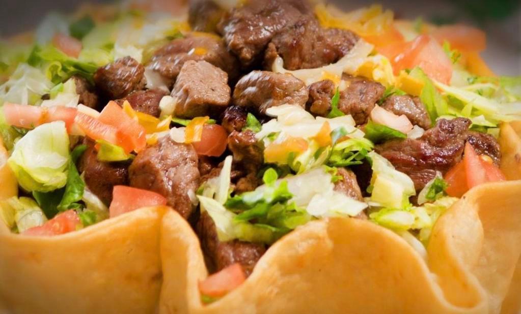 Taco Salad · Large crisp tortilla shell, filled with choice of pinto beans or white rice and a combo of green leaf and iceberg lettuce, shredded cheddar cheese and diced tomato. Served with salsa rojo or verde, and guacamole on the side.