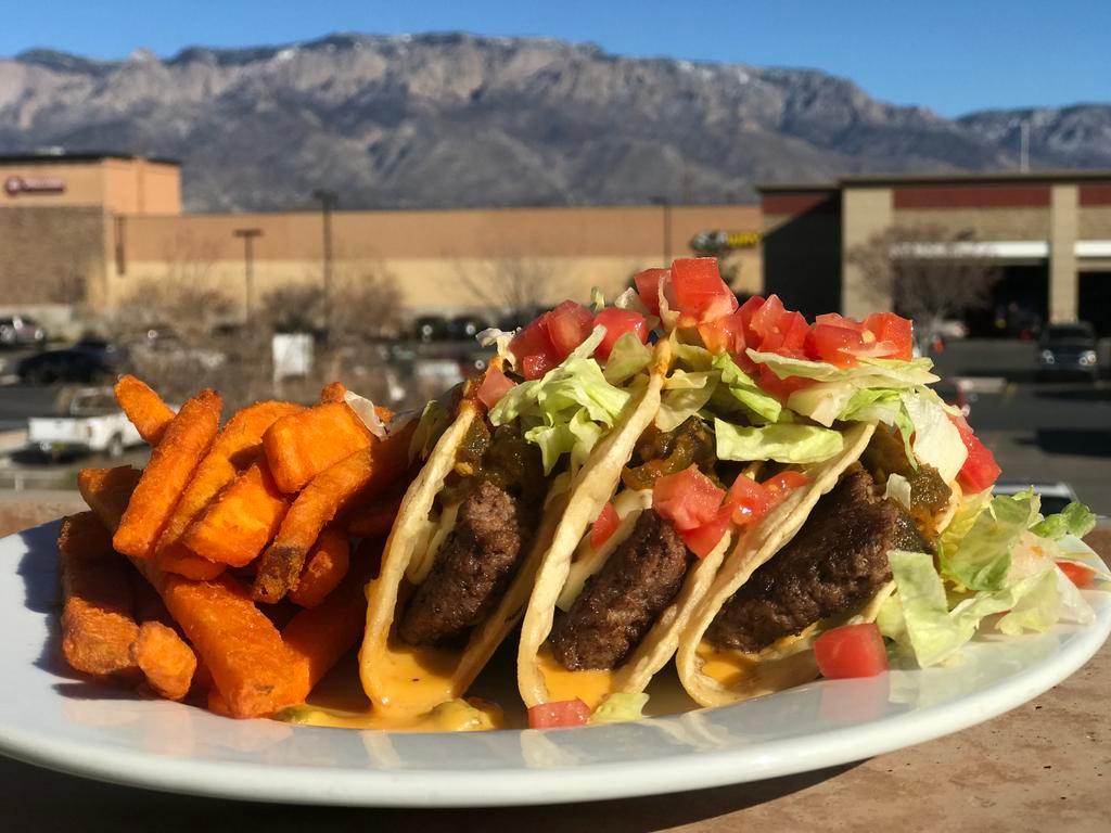 Emma's Taco Burger Plate · 3 crisp taco shells, with fresh Angus chuck ground steak, sliced American cheese, filled with frank Sr.'s special taco burger hot chile sauce and Chile con queso, lettuce, tomato and onion.
