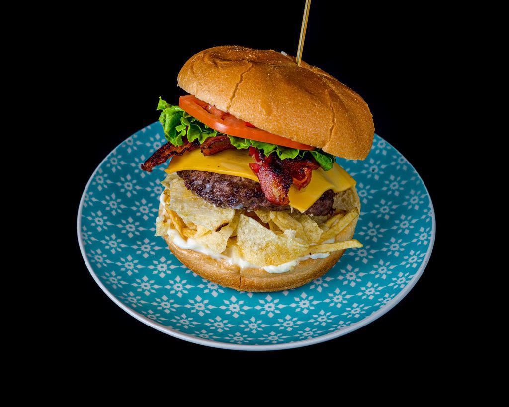 La Colombiana Burger · Beef patty, bacon, cheese, lettuce, tomato, crushed potato chips, pineapple sauce, mayo & ketchup.