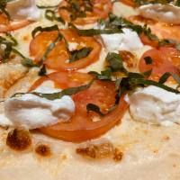 Tomato Ricotta Pizza · Garlic butter sauce, mozzarella cheese, sliced tomatoes, creamy ricotta and fresh basil.