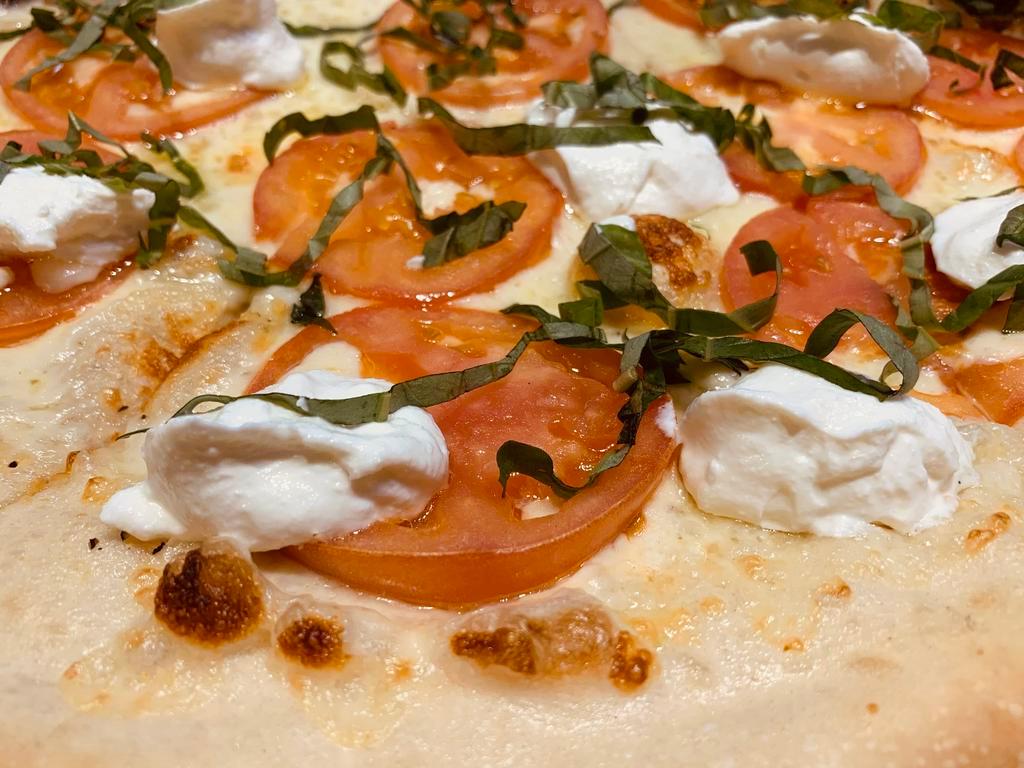 Tomato Ricotta Pizza · Garlic butter sauce, mozzarella cheese, sliced tomatoes, creamy ricotta and fresh basil.