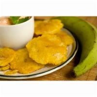 Tostones · Dominican style green plantains, flattened and fried to golden medallions, lightly sprinkled...