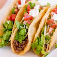 2. Three Ground Beef Tacos · 3 soft or hard shell tortillas filled with ground beef and cheese. Served with rice, beans, ...