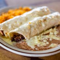 11. Flautas · Chicken rolled up in field corn tortillas topped with cheese, sour cream. Served with rice, ...