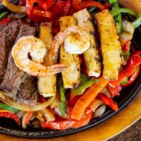 16. Combo Fajitas · Chicken and beef and shrimp sauteed with garlic, onion, and peppers. Served with lettuce, pi...