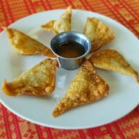 Fried Wontons · 6 pieces. Stuffed with ground pork and onions. Served with our house sauce.