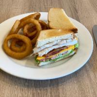 Club House Sandwich · Roasted turkey, smoky bacon, cheddar, lettuce, tomato, pickles and mayo. Served with house f...