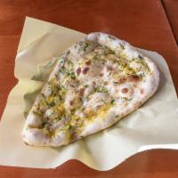 Garlic Naan · Naan topped with fresh garlic and cooked in tandoor oven