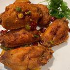 Spicy Chicken Wings Sichuan Style · Cooked wing of a chicken coated in sauce or seasoning.