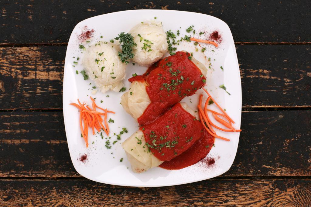 Stuffed Cabbage / Gołąbki · Leaves of cabbage stuffed with pork and rice. Two golabki served with mashed potatoes and zesty tomato sauce.
