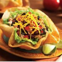 Taco Salad · seasoned ground beef in a homemade edible flour tortilla shell, topped with fresh lettuce, t...