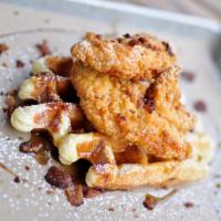 Chicken and Waffles · Fried chicken tenders with bacon crumble and maple syrup on top of our golden Liege waffle.