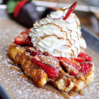 The House Waffle · Fresh cut strawberries, Nutella, cookie butter, and house made whipped cream on our golden L...