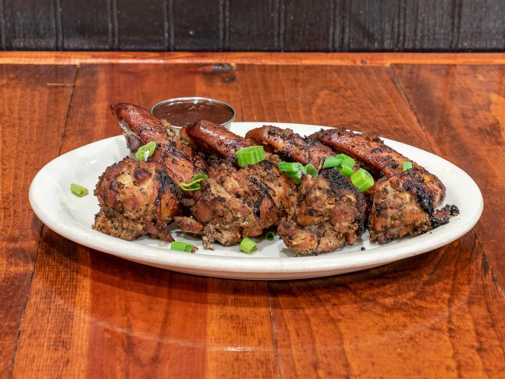 Jerk Chicken Wings with fries · 4 whole wings in Jamaican jerk  fried or grilled w/fries