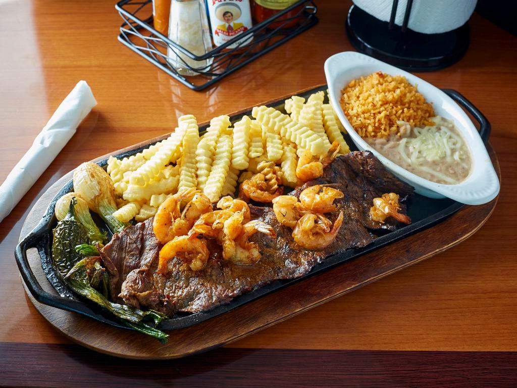 Carne Asada con Camarones Plancha · Char-broiled steak with griddled shrimp served with rice, beans, fries, grilled onions, and jalapeno pepper.