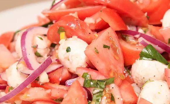 Tomato Salad · Garden tomatoes, onions, garlic, basil, parsley, fresh mozzarella & extra virgin olive oil dressing.