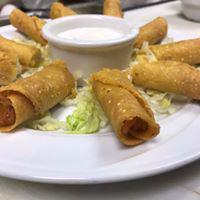 Taquitos · Served with tomatoes and sour cream sauce.