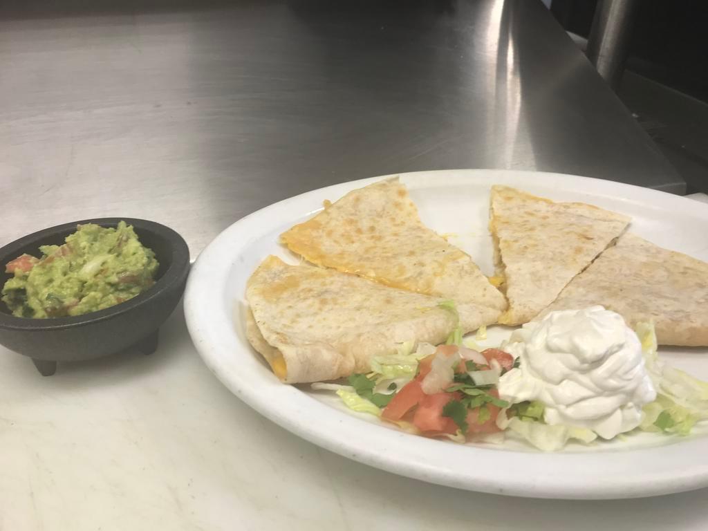 Quesadilla · A grilled flour tortilla with cheese garnish with lettuce, tomatoes and sour cream.