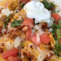 Nachos · Tortilla chips topped with beans, lettuce, ground beef and melted cheese. Cover with tomatoe...