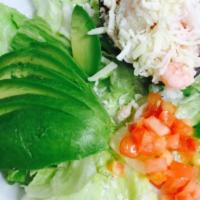 Palta Rellena Salad · Ripe avocado, pitted and filled with shrimp and crab salad. Topped with tomatoes and jack ch...