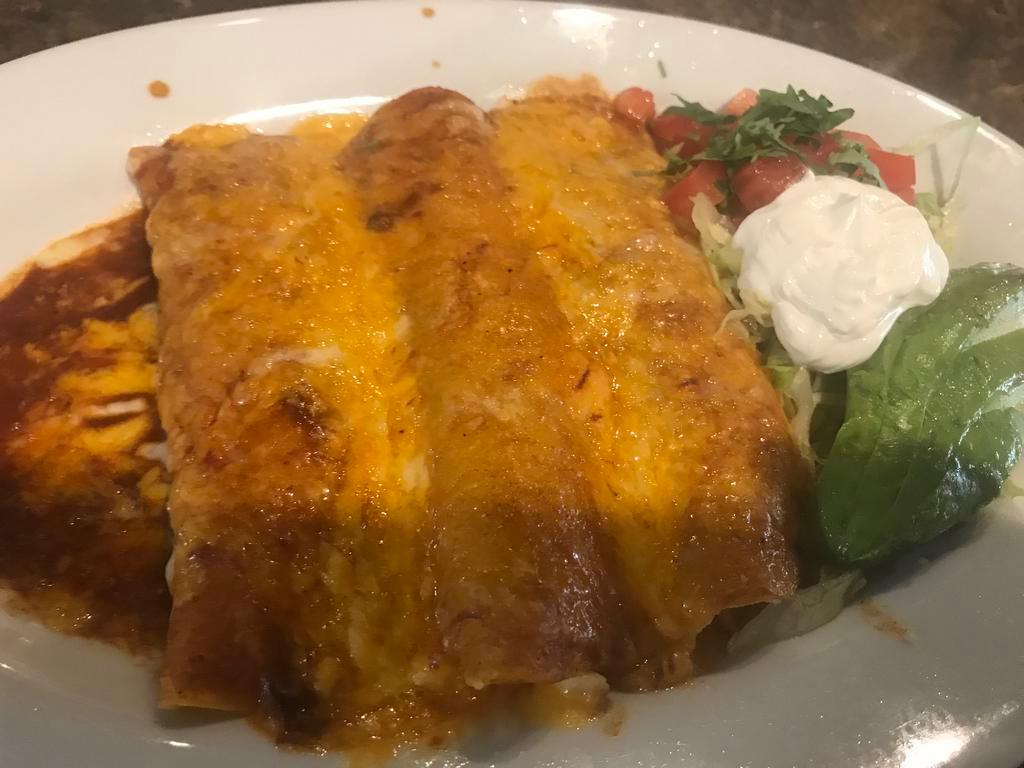 2 Enchiladas Combo · Two delicious enchiladas filled with your choice seasoned chicken, ground beef, shredded beef, or cheese, Served with rice and beans.
