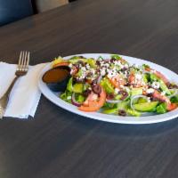 Greek Salad · Hearts of romaine, diced tomatoes, red onion, Kalamata olives and feta cheese.