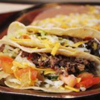 11. Ground Beef Taco Plate · Three- 6' regular size corn tortilla tacos made with  ground beef. Served with beans, rice, ...