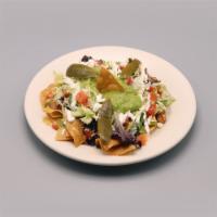 Nachos Rancheros · Tortilla chips, beans, cheese, lettuce, onions, pico de gallo, jalapeno, and sour cream.