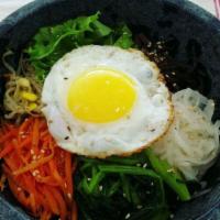 B2. Hot Stone Bibimbap · A bowl of rice topped with various Namul(seasoned vegetable), fried egg, and your choice of ...
