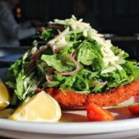 Chicken Milanese · Breaded chicken cutlet, arugula, tomato, parmigiano, pickled red onions.