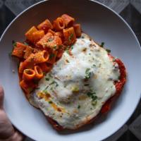 Chicken Parm · Chicken cutlet smothered with tomato sauce, fresh mozzarella. Served with rigatoni and pomod...