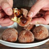 Bomboloni Donut Holes · Fresh donut holes stuffed with nutella cream, rolled in cinnamon sugar.