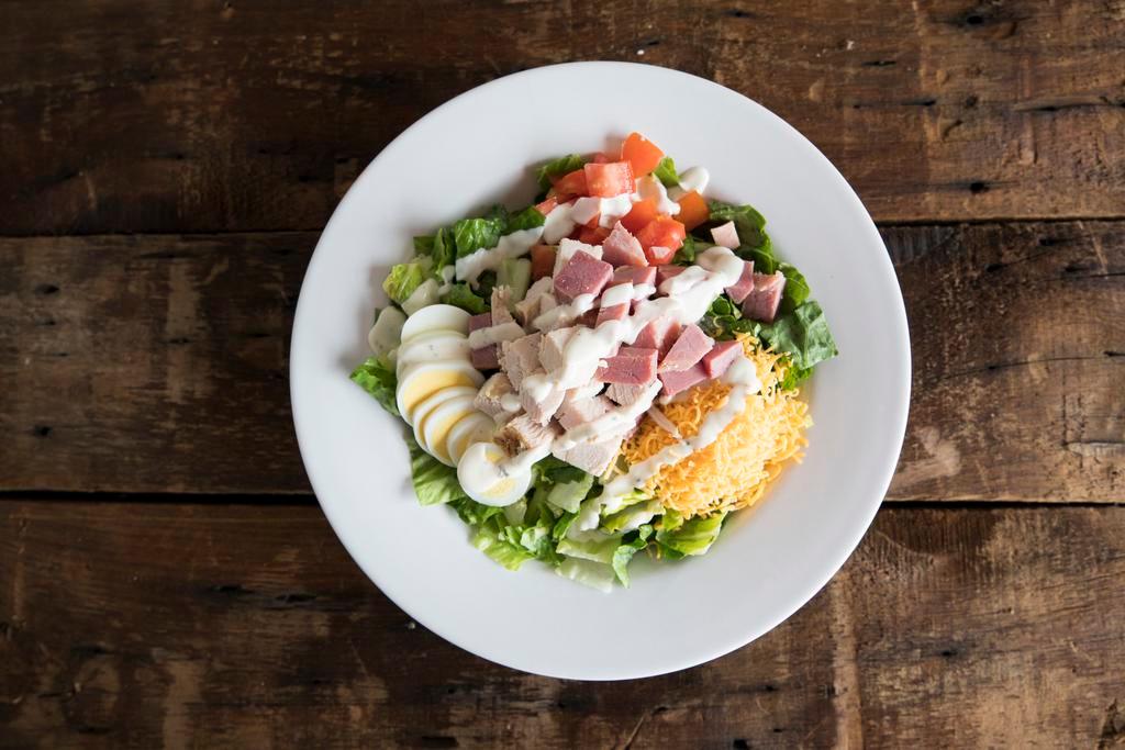 Dr. Super Chef Salad · Crisp romaine, tomatoes, sliced egg, cheddar, croutons, ham, turkey and choice of dressing.