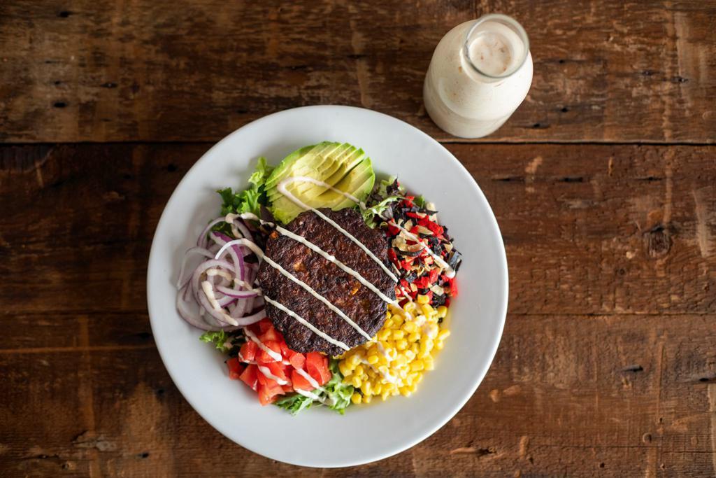 Dr. Chipotle Salad · Field greens, avocado, red onion, tomatoes, sweet corn, crispy tortilla strips, chipotle black bean burger and chipotle ranch dressing.