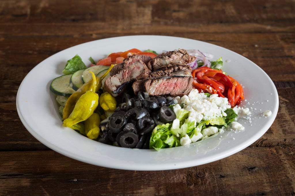 Dr. Greek Salad · Crisp romaine, tomatoes, roasted red peppers, feta, pepperoncini, black olives, cucumbers, red onion and Athenian Greek dressing. Low carb.