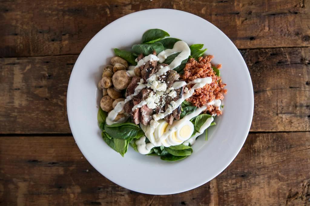 Dr. Detroit Salad · Baby spinach, roasted button mushrooms, bacon, sliced egg and chunky bleu cheese dressing.