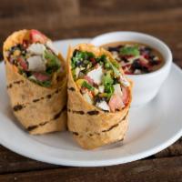 Fiesta Chicken Wrap · Sun-dried tomato wrap, crisp romaine, tomatoes, shredded carrots, cheddar, black bean and co...