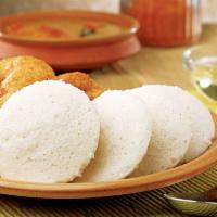 Idly Sambar · A South Indian staple – steamed rice & lentil dumplings served with sambar and coconut chutn...