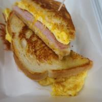 Sourdough Breakfast Sandwich · Grilled sourdough bread with jack and cheddar cheese, scrambled eggs, and grilled ham.