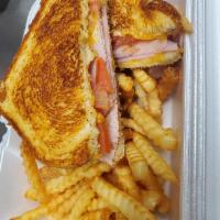 Grilled Ham and Cheese Sandwich · Grilled ham with cheddar cheese, sliced tomatoes, on sourdough bread, served with french fri...