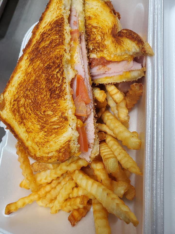 Grilled Ham and Cheese Sandwich · Grilled ham with cheddar cheese, sliced tomatoes, on sourdough bread, served with french fries.
