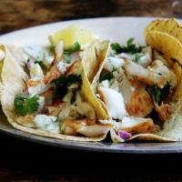Fish Taco · Grilled tilapia served on corn tortillas with tomatillo salsa, mayo, pico de gallo served wi...