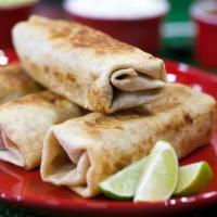 Chimi Plate Lunch · 1 chimichanga (shredded chicken or beef) fried, covered in cheese sauce and ranchero sauce w...