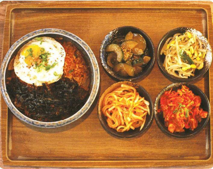 Kimchi Fried Rice · Fried rice with ripened kimchi topped with egg and seaweed flakes.
